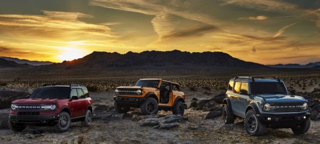 Pre-production versions of the all-new 2021 Bronco family of all-4x4 rugged SUVs, shown here, include Bronco Sport in Rapid Red Metallic Tinted Clearcoat, Bronco two-door in Cyber Orange Metallic Tri-Coat and Bronco four-door in Cactus Gray. 