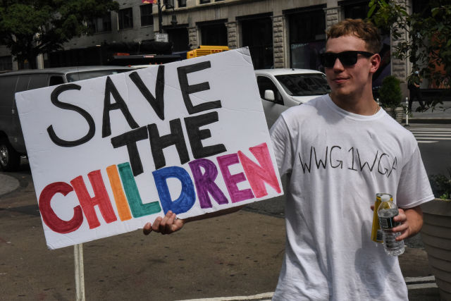 A person wears a t-shirt with the anagram WWG1WGA, the QAnon slogan, while participating in a "save the children" march and rally in New York City, New York, U.S. August 12, 2020. REUTERS/Stephanie Keith
